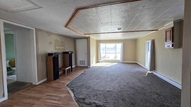 416 S Michigan Ave, Manton, MI 49663 - unfurnished living room featuring baseboard heating, wood finished floors, and baseboards
