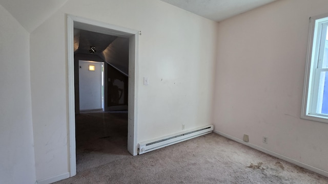 416 S Michigan Ave, Manton, MI 49663 - spare room featuring a baseboard radiator, carpet, vaulted ceiling, and baseboards