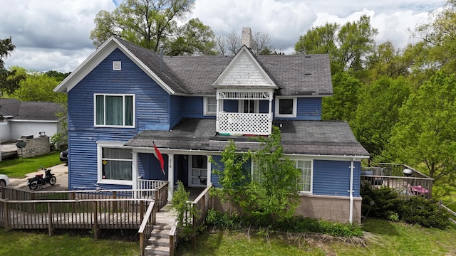416 S Michigan Ave, Manton, MI 49663 - victorian house with a wooden deck, a chimney, and a shingled roof