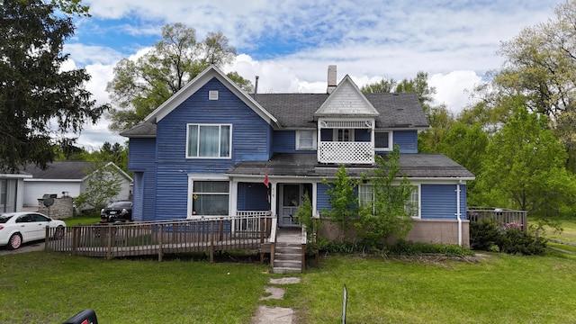 416 S Michigan Ave, Manton, MI 49663 - victorian-style house featuring a chimney, a front yard, and a shingled roof