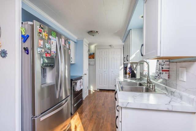 kitchen with stainless steel appliances, sink, white cabinetry, ornamental molding, and dark hardwood / wood-style floors