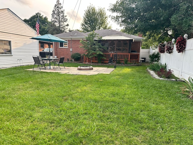 view of yard featuring a fire pit and a patio