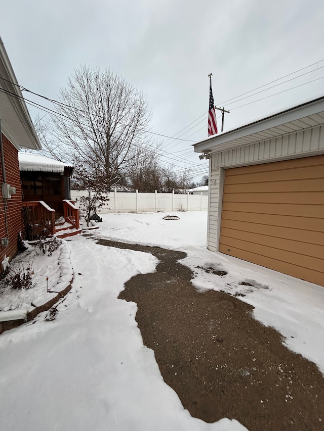 yard layered in snow with a garage