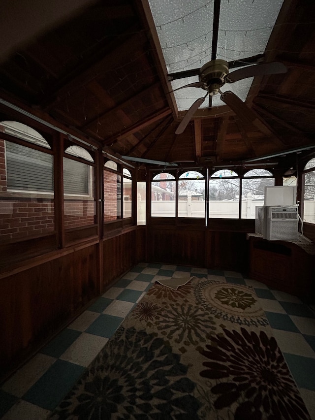 sunroom / solarium with vaulted ceiling, ceiling fan, and cooling unit