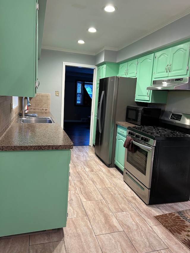 kitchen featuring stainless steel appliances, ornamental molding, green cabinetry, and sink