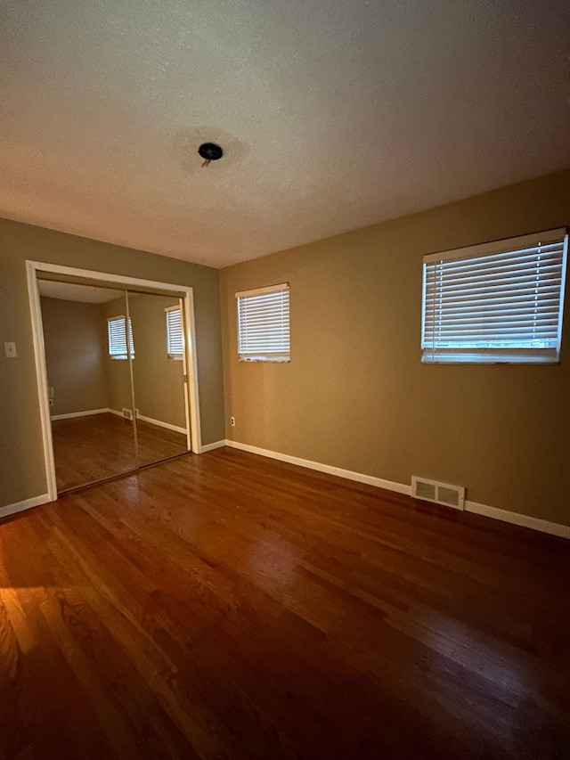 empty room featuring dark hardwood / wood-style flooring