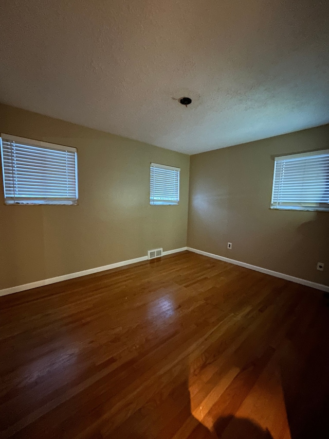 unfurnished room featuring wood-type flooring