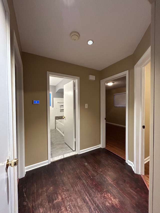 hallway with hardwood / wood-style flooring