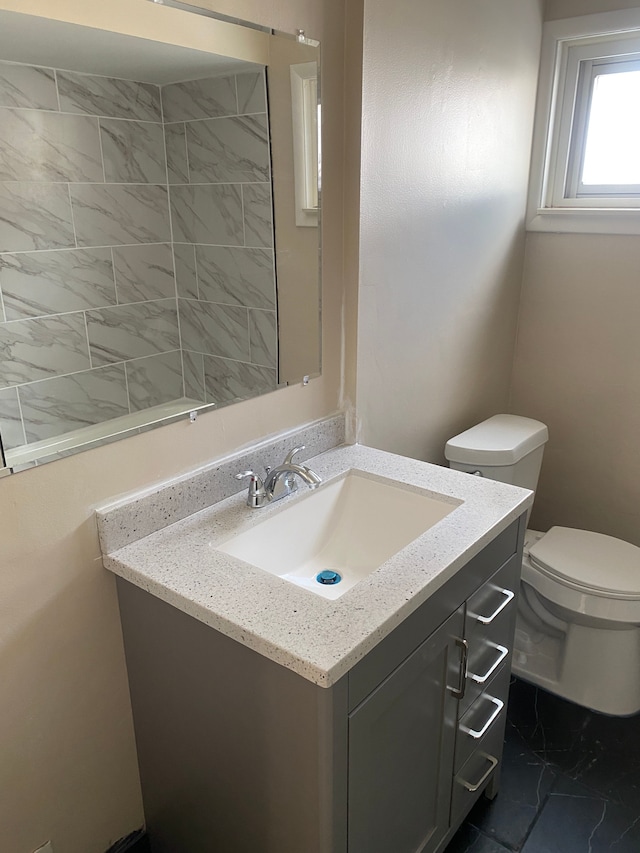 bathroom featuring vanity and toilet