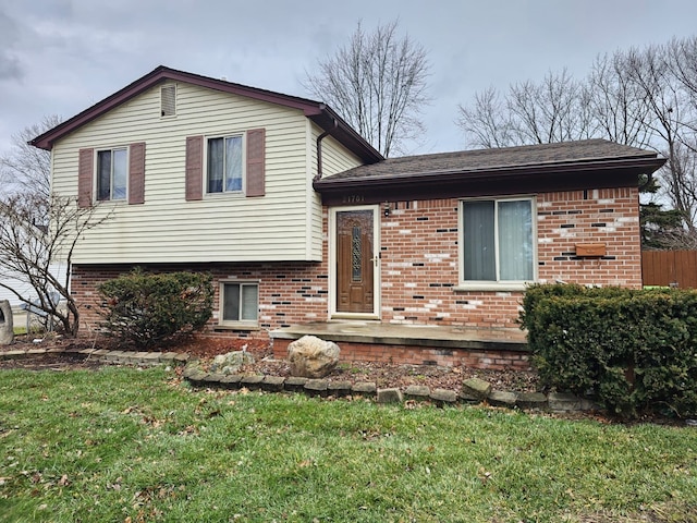 tri-level home with a front lawn