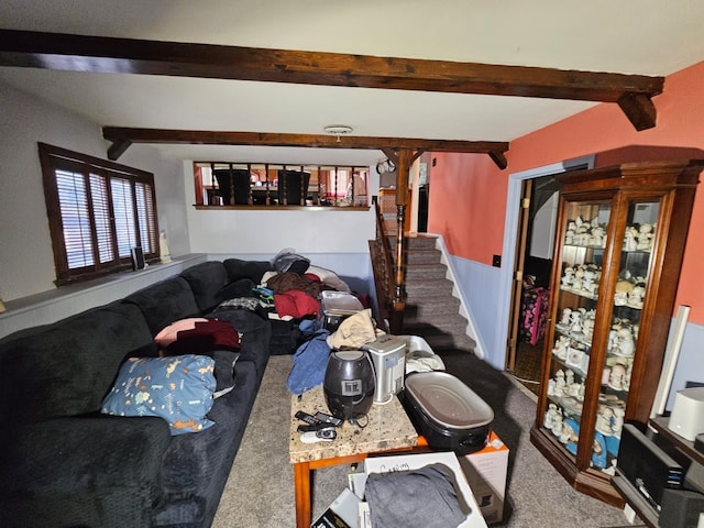 carpeted living room featuring beamed ceiling