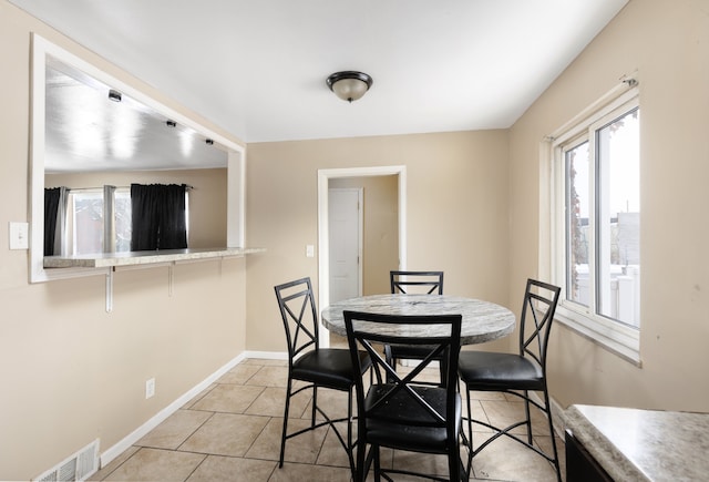 dining area with light tile patterned flooring