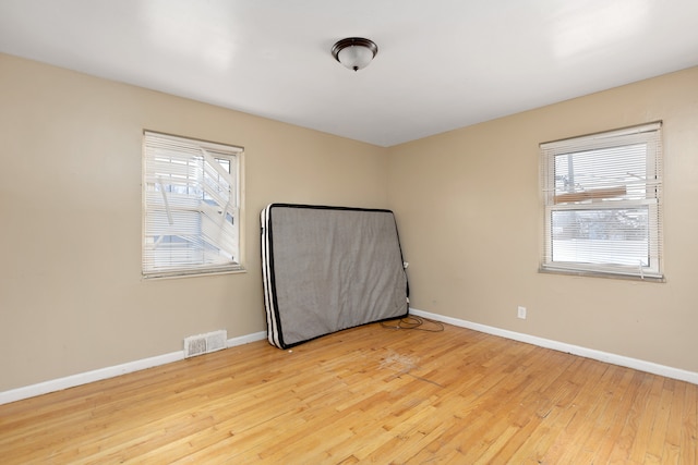 unfurnished room with light wood-type flooring