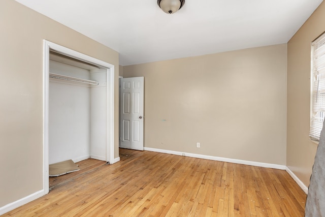 unfurnished bedroom featuring light hardwood / wood-style floors and a closet