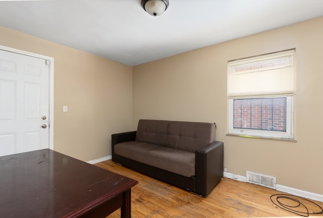 sitting room with hardwood / wood-style flooring