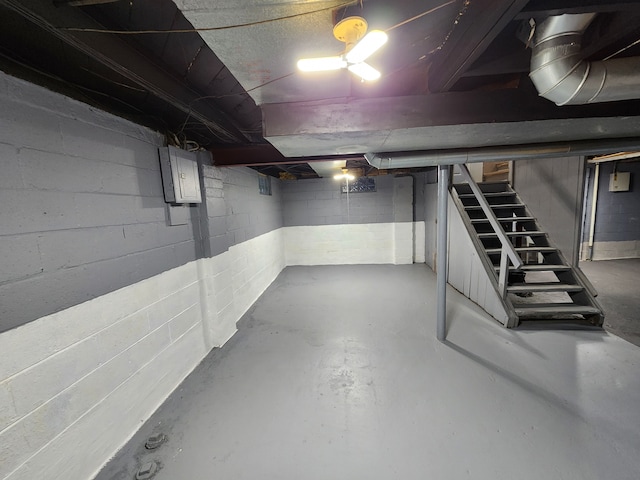 unfinished below grade area featuring stairs and electric panel