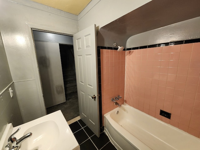 full bathroom with shower / washtub combination, tile patterned flooring, and a sink