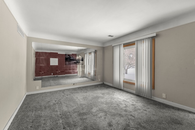 unfurnished living room featuring carpet flooring