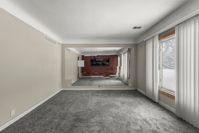 unfurnished living room featuring carpet floors