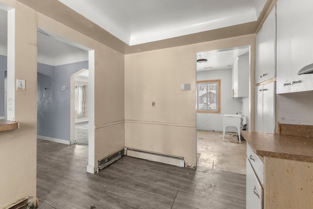 interior space featuring a baseboard radiator and dark hardwood / wood-style flooring