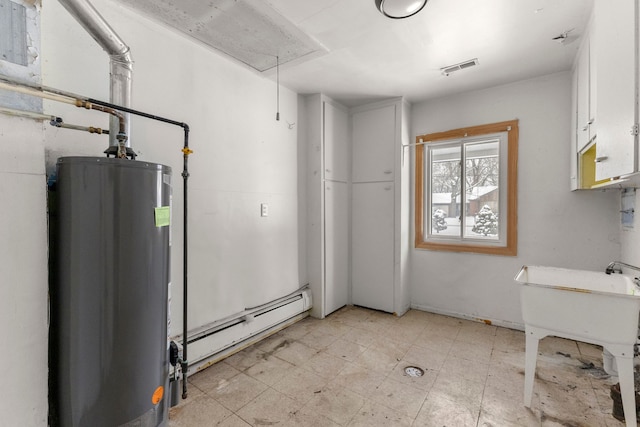 utility room featuring a baseboard heating unit and gas water heater