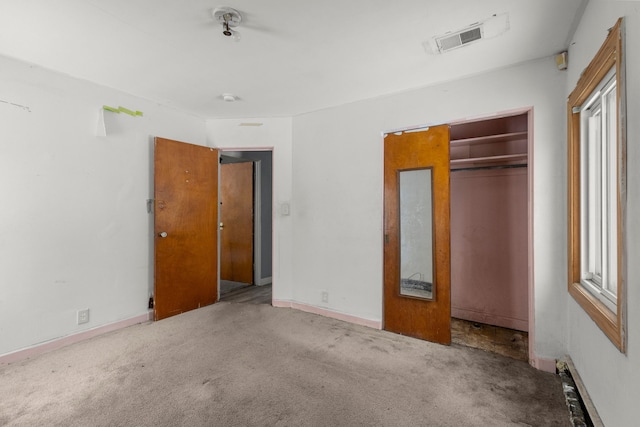 unfurnished bedroom featuring carpet flooring and a closet