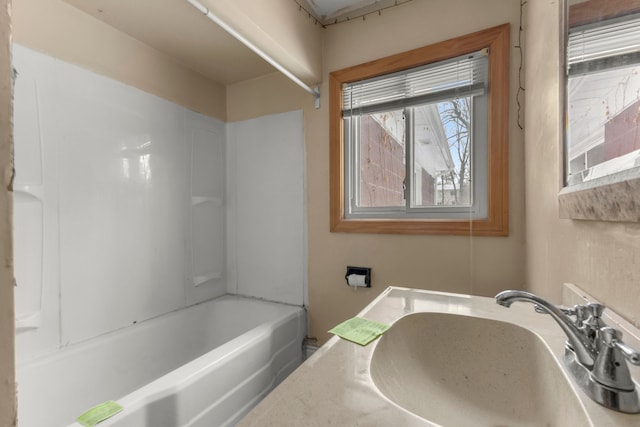 bathroom featuring bathing tub / shower combination and sink