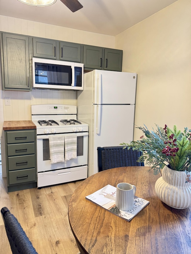 kitchen with white appliances, light hardwood / wood-style floors, and gray cabinetry