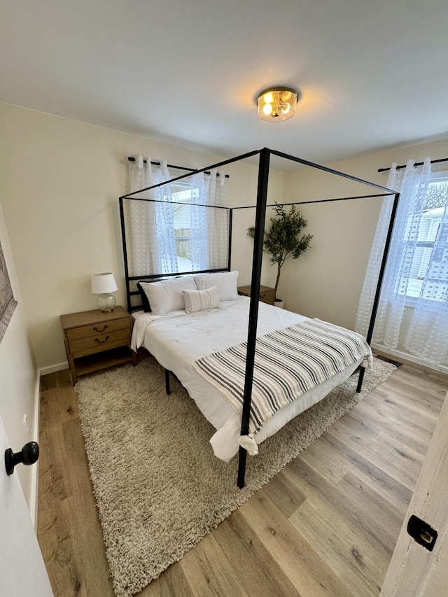 bedroom with hardwood / wood-style flooring