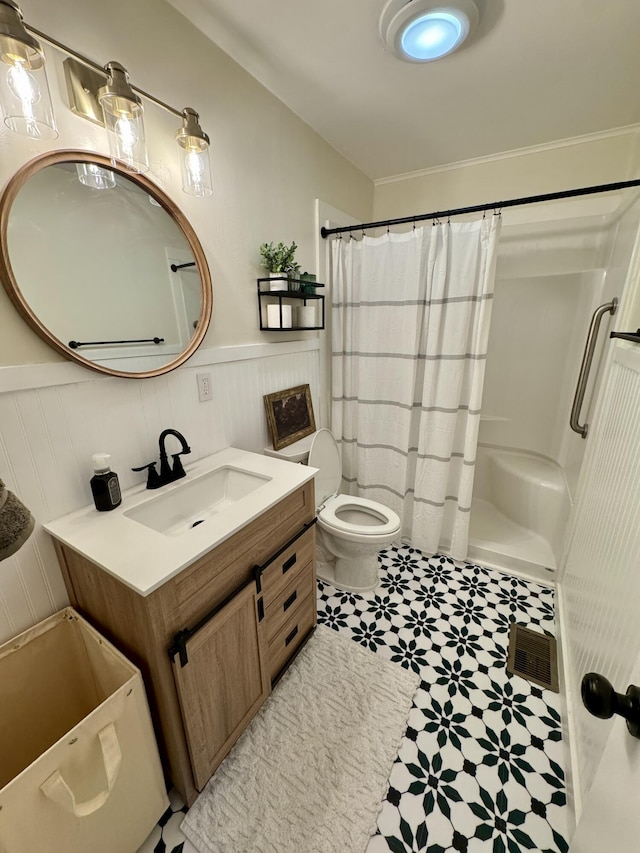 bathroom featuring vanity, curtained shower, and toilet