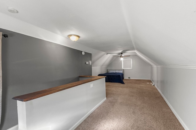 additional living space featuring carpet flooring, ceiling fan, and vaulted ceiling