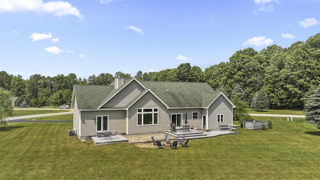 rear view of house featuring a lawn, a patio area, and central air condition unit