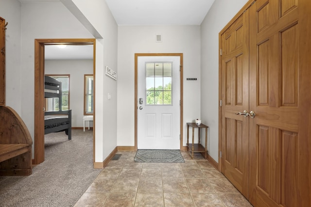 entryway with light colored carpet