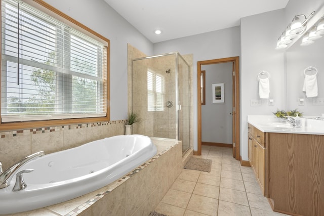 bathroom featuring tile patterned flooring, independent shower and bath, and vanity