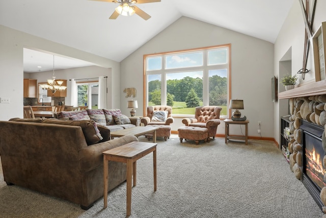living room featuring ceiling fan with notable chandelier, a fireplace, lofted ceiling, and carpet