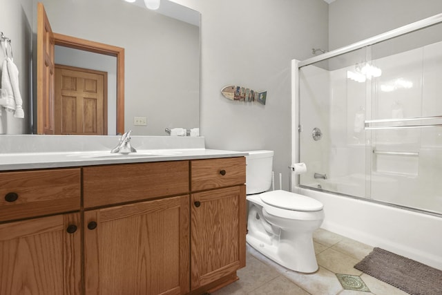 full bathroom with toilet, vanity, tile patterned floors, and combined bath / shower with glass door
