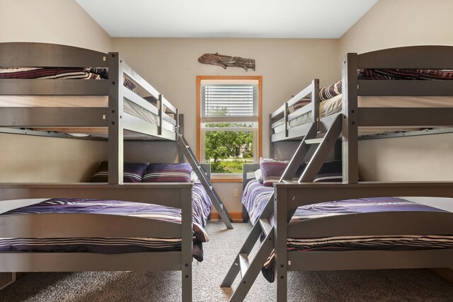 bedroom with lofted ceiling and carpet floors