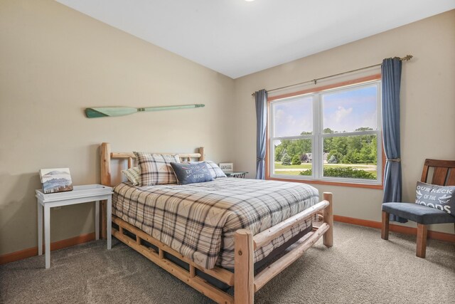 bedroom featuring lofted ceiling and carpet flooring