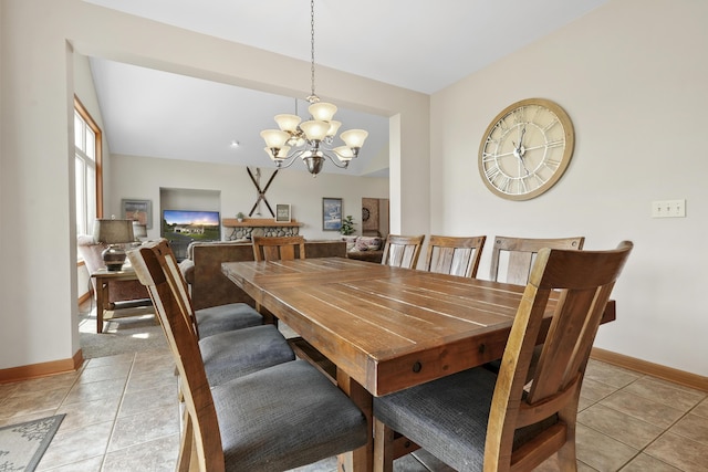 tiled dining room featuring an inviting chandelier