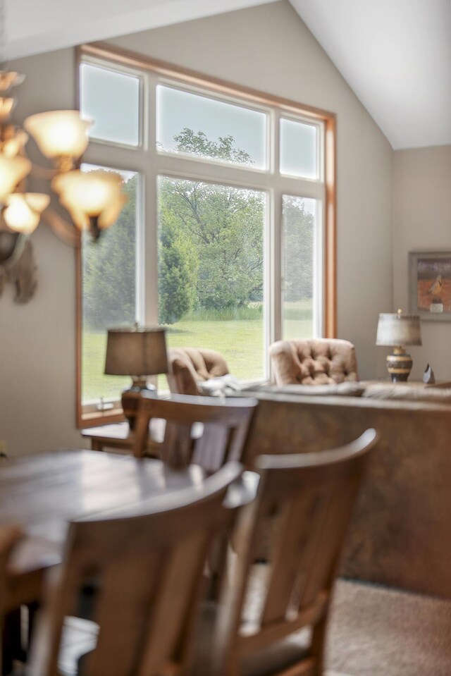 dining space with lofted ceiling