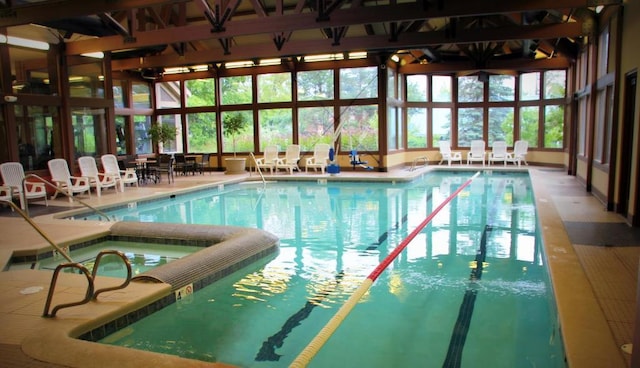 view of swimming pool with an indoor hot tub