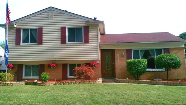 tri-level home with a front yard