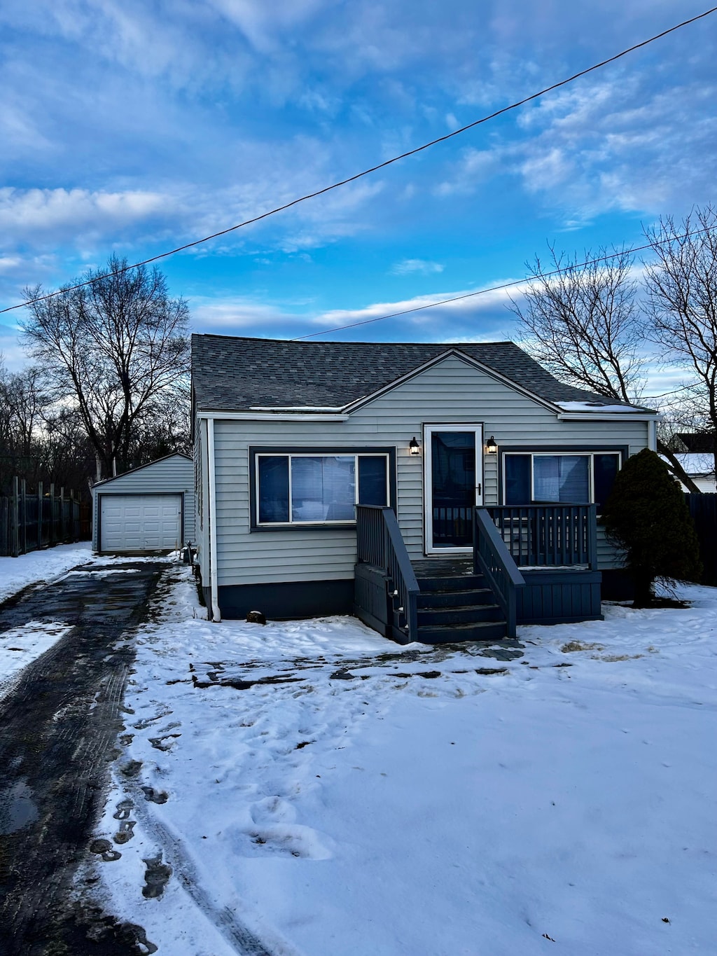 view of front of property with a garage and an outbuilding