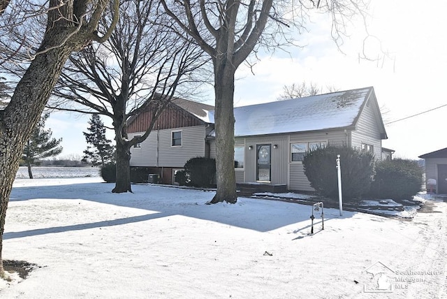 view of snow covered back of property