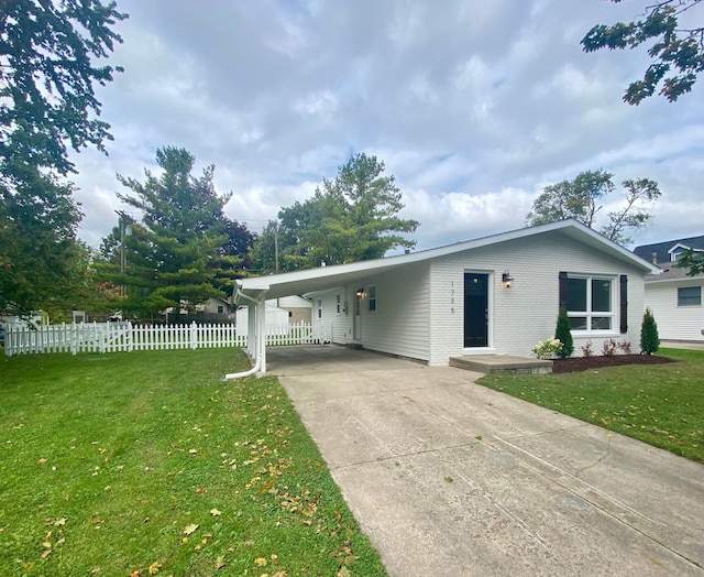 ranch-style home featuring a front yard and a carport