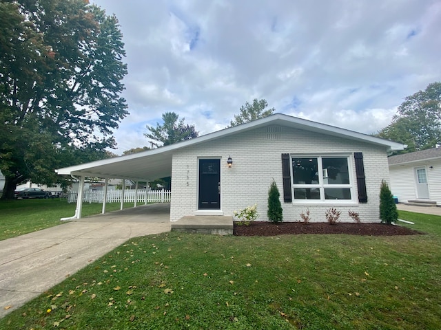 view of front facade with a front lawn and a carport