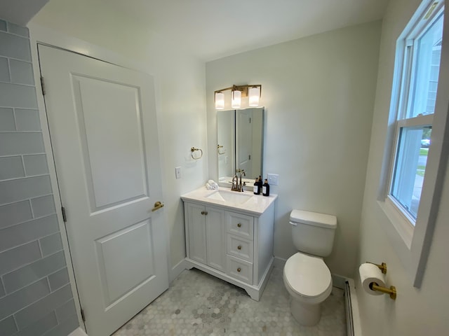 bathroom with toilet, a baseboard heating unit, and vanity