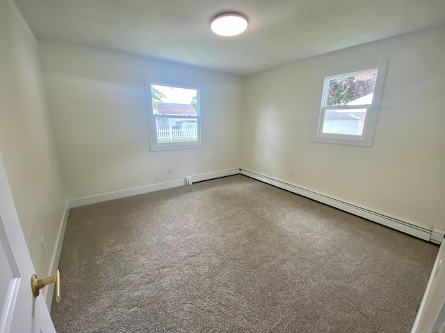 unfurnished room featuring a baseboard radiator and carpet flooring