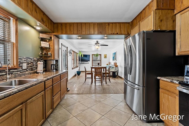 kitchen with stainless steel appliances, light tile patterned floors, ceiling fan, sink, and tasteful backsplash