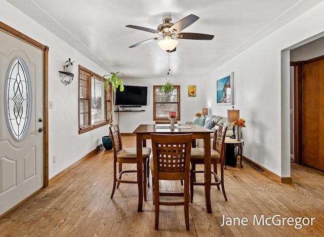 dining space with ceiling fan and light hardwood / wood-style floors